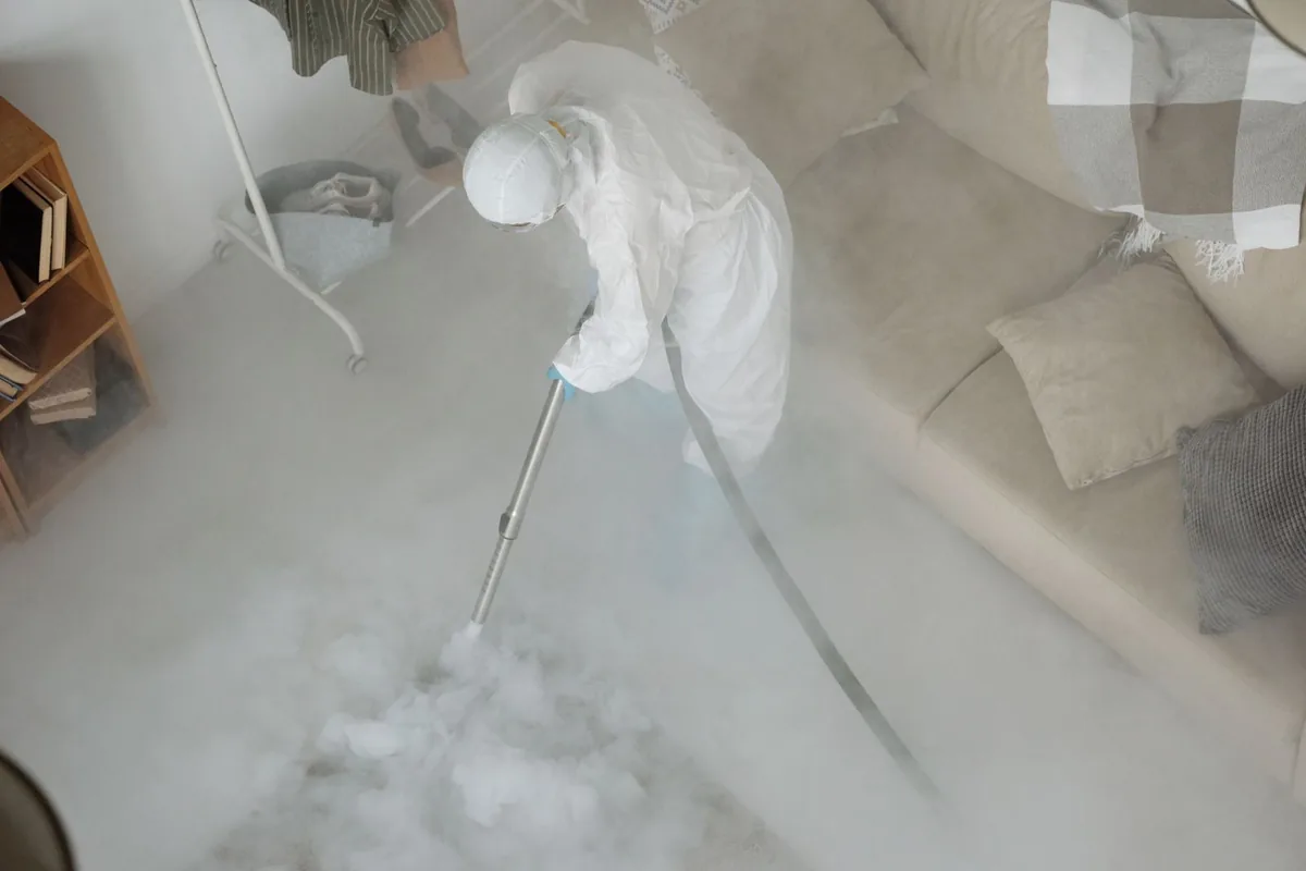 Biohazard cleanup technician in protective equipment, Mission, KS